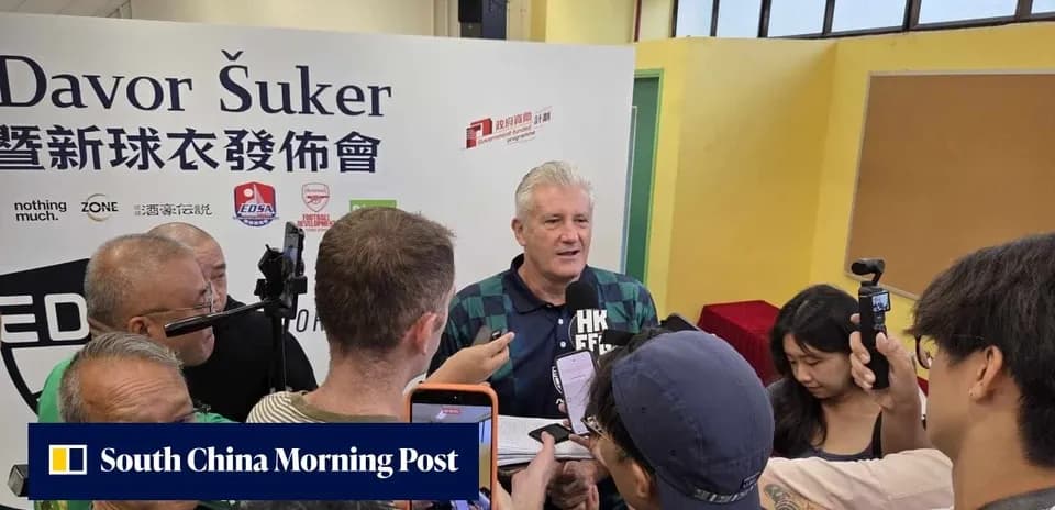 Davor Šuker speaking at a press conference surrounded by reporters