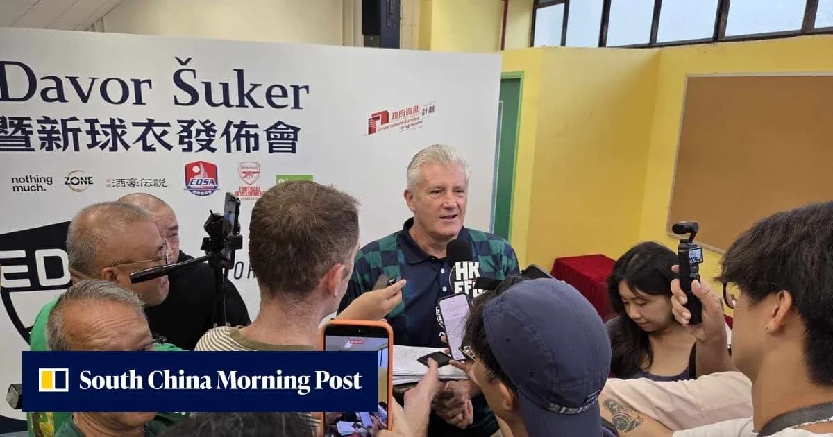Davor Šuker speaking at a press conference surrounded by reporters