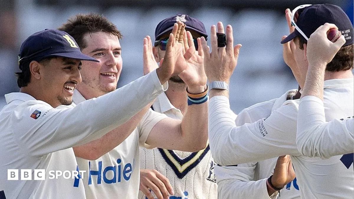 Cricket players celebrating a wicket on the field