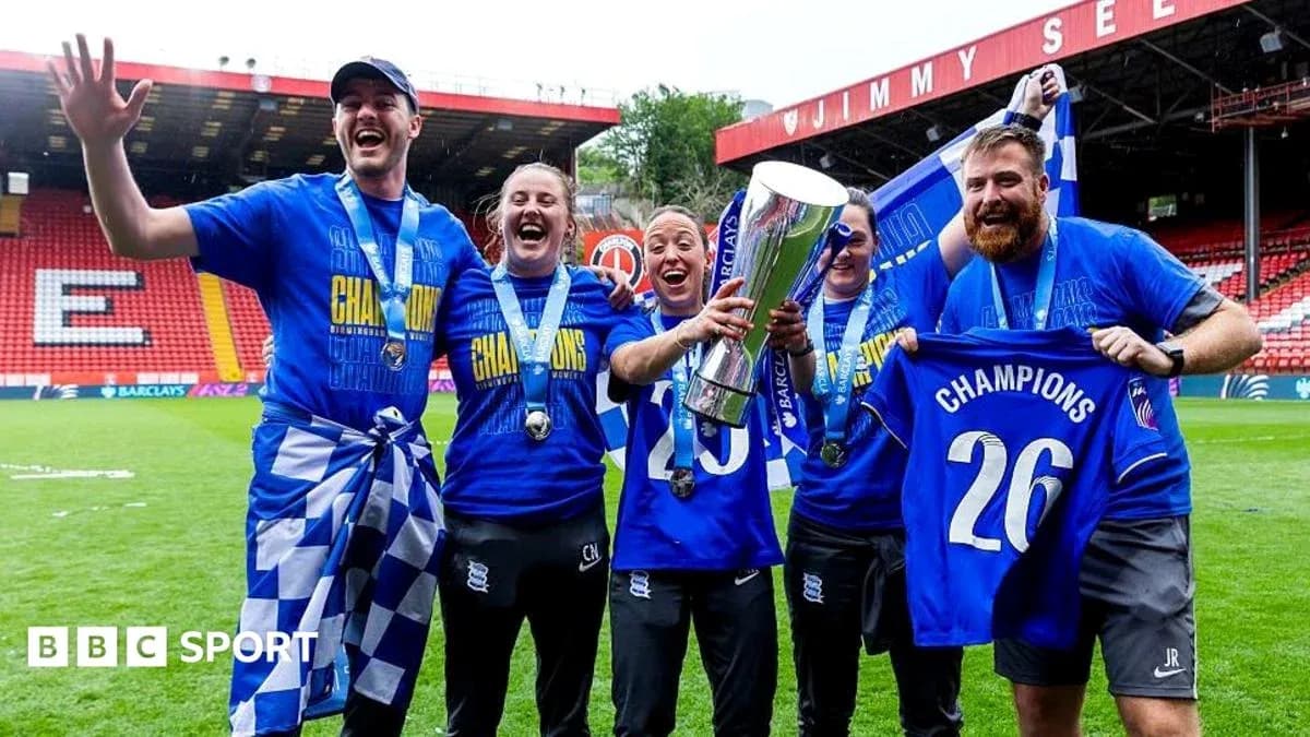 Birmingham City players celebrating with trophy and medals