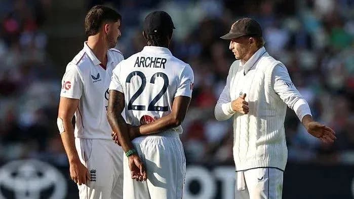 Players discussing strategy during cricket match
