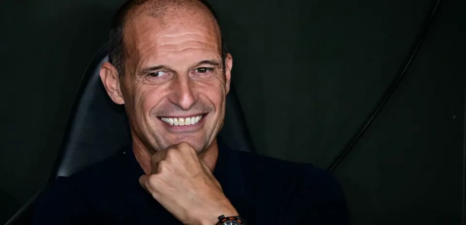 Coach smiling while seated in a chair