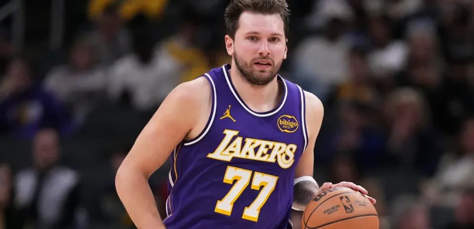 Player dribbling basketball in Lakers uniform