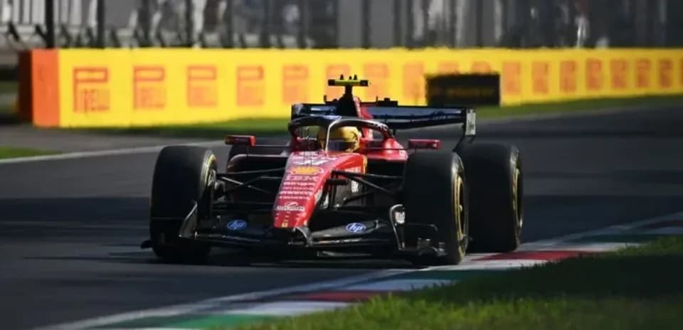Ferrari car navigating a corner on racetrack
