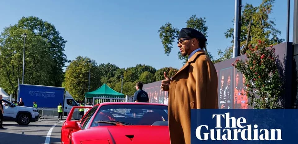Person standing beside a red sports car outdoors