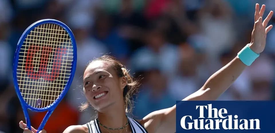 Tennis player celebrating with racket raised in victory