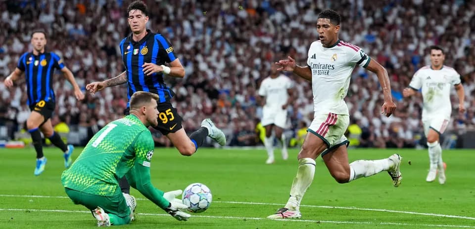 Goalkeeper diving as players contest ball during match