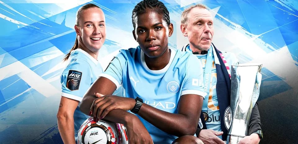 Three Manchester City players posing with a trophy