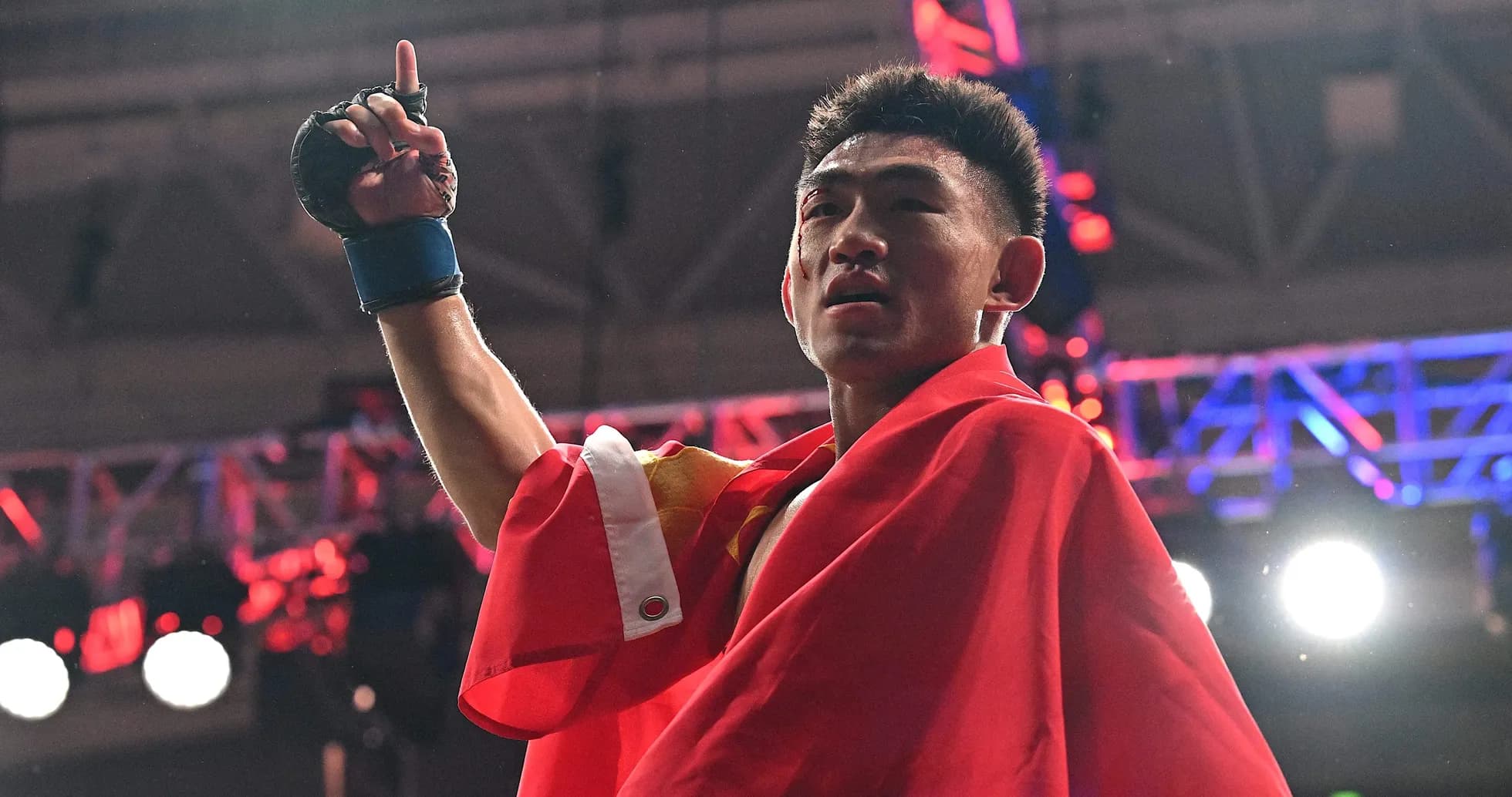 Boxer celebrating victory with flag in arena