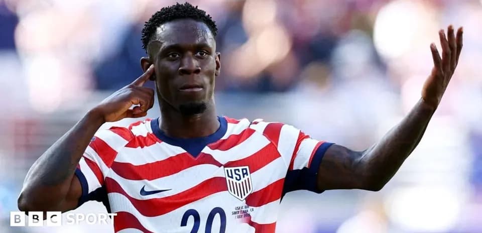 Player celebrating with hand gesture in USA jersey
