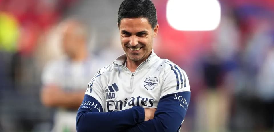 Arsenal manager smiling during a match warm-up