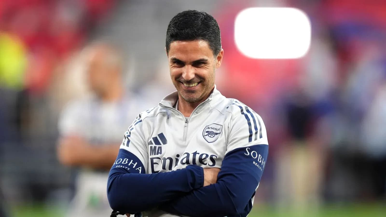 Arsenal manager smiling during a match warm-up