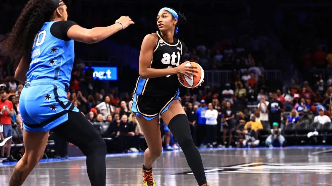 Player dribbling basketball while being guarded during game