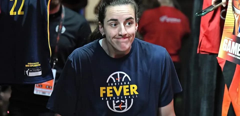 Player in Indiana Fever shirt walking in tunnel