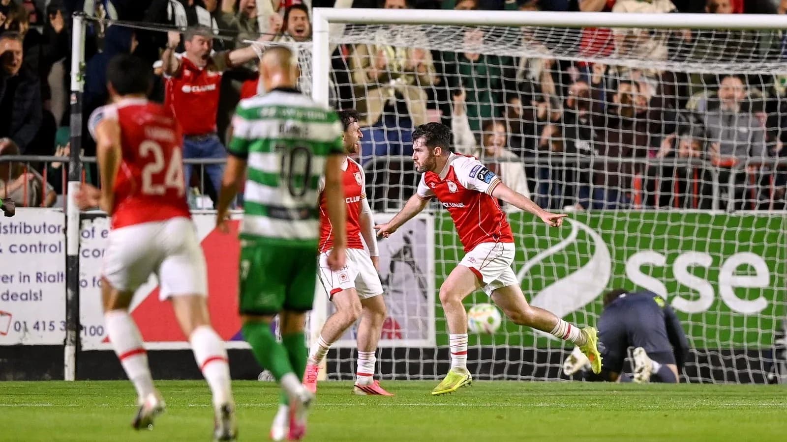 Player celebrating a goal with teammates in match