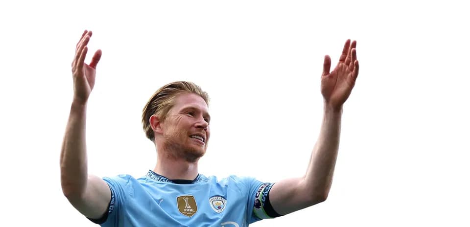 Player celebrating with arms raised in Manchester City jersey