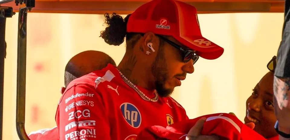 Driver interacting with a fan while wearing team gear