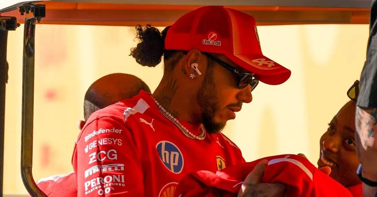 Driver interacting with a fan while wearing team gear