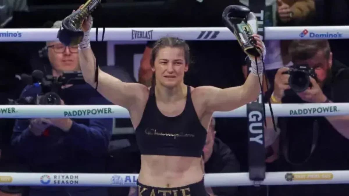 Katie Taylor celebrating victory in boxing ring