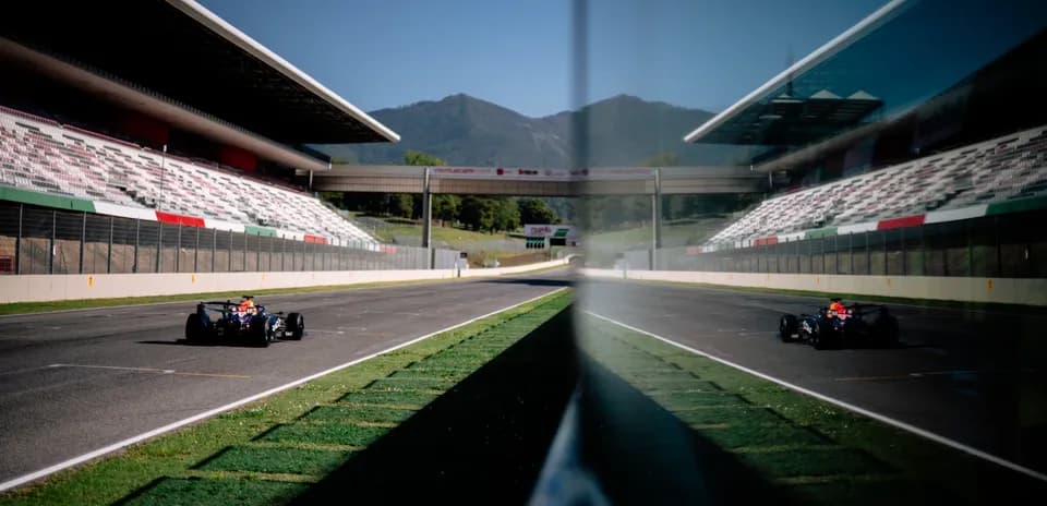 Race car on track with grandstands in background
