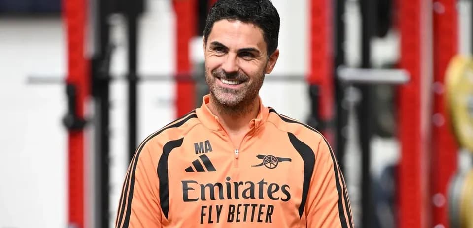 Coach in training gear smiling during session