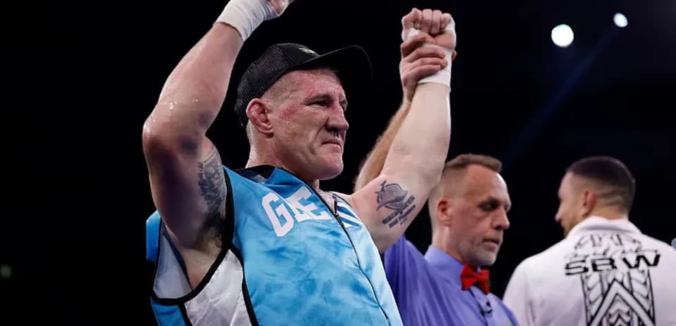 Boxer celebrating victory with referee after match