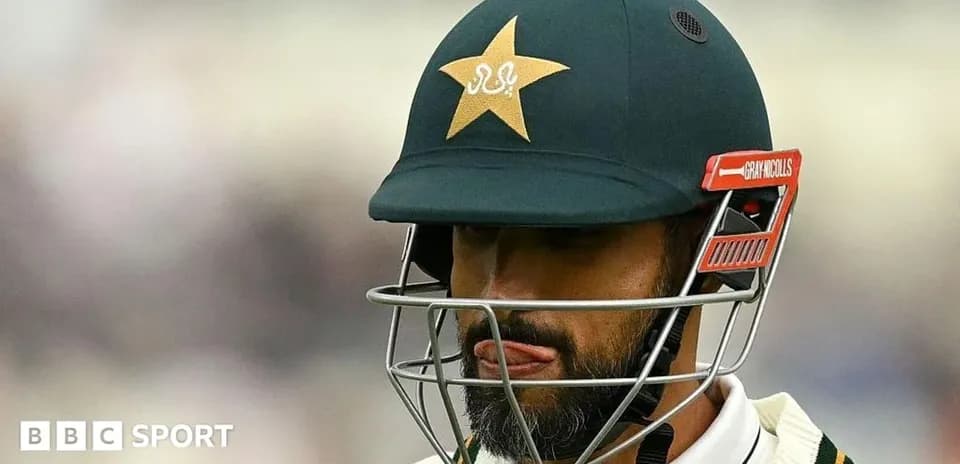 Cricketer wearing helmet with Pakistan team logo