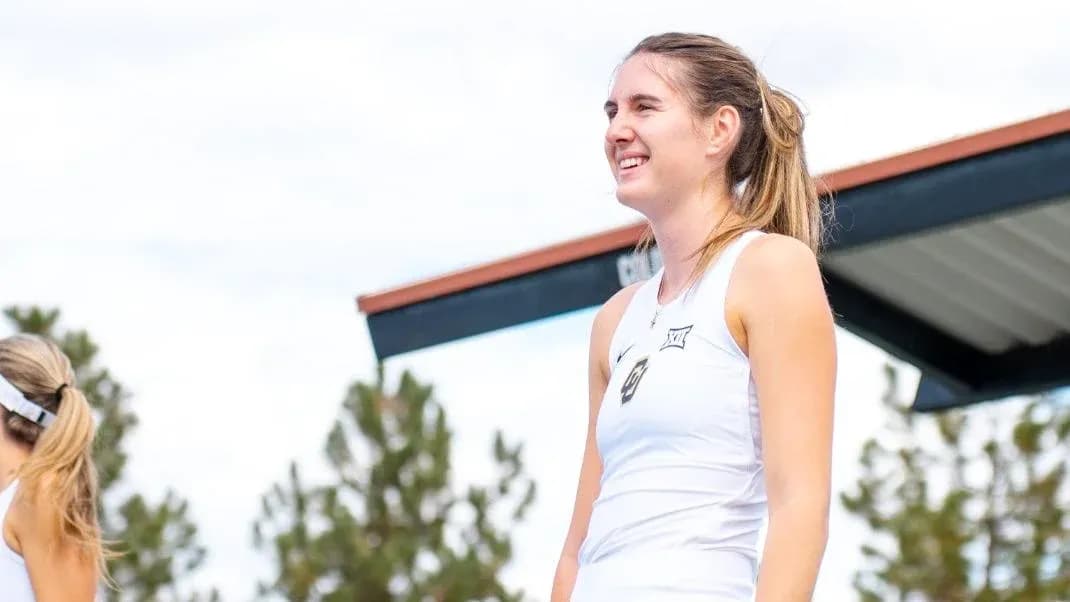 Female tennis player on court smiling during event
