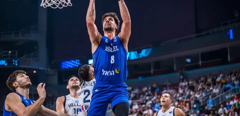 Player jumping for a dunk during basketball match