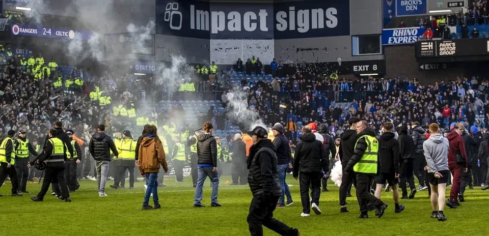 Fans and police on the pitch after match