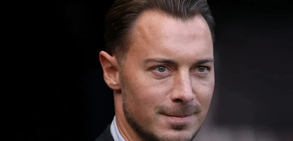 Man in suit with short hair and facial hair