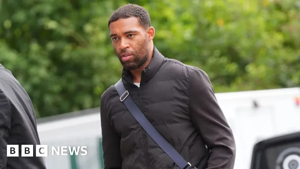 Player walking with bag in casual outfit