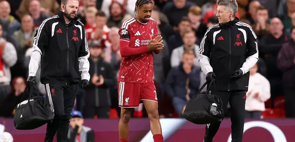 Liverpool player being assisted off the pitch