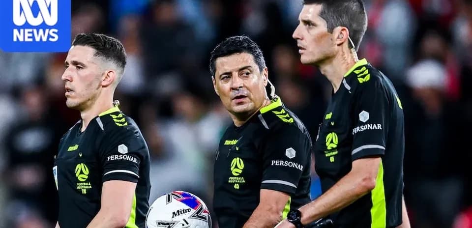 Three referees discussing during a football match