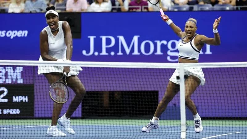 Venus and Serena Williams celebrating on the court