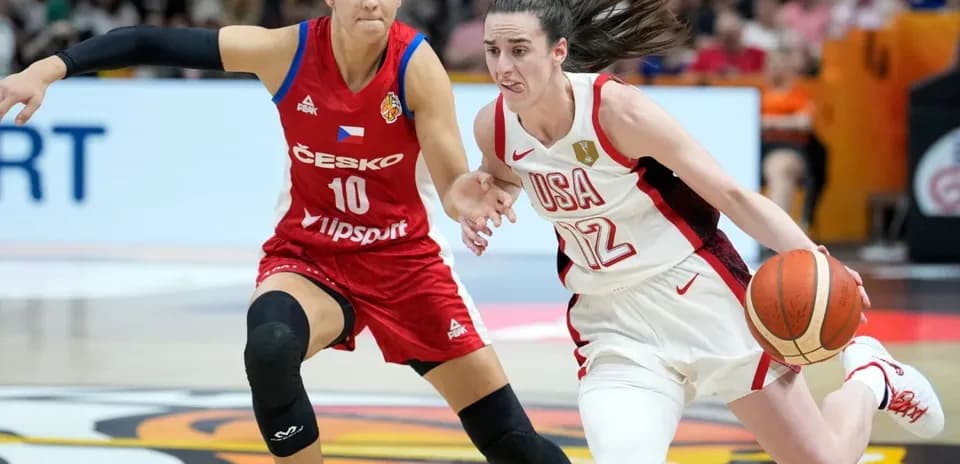 USA player dribbling past Czech player during game