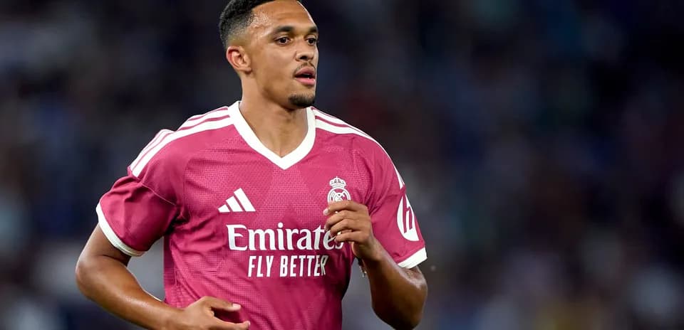 Player running in pink Real Madrid jersey on field