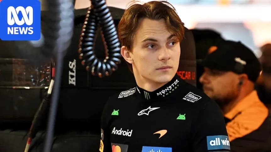 Driver in McLaren team uniform in garage