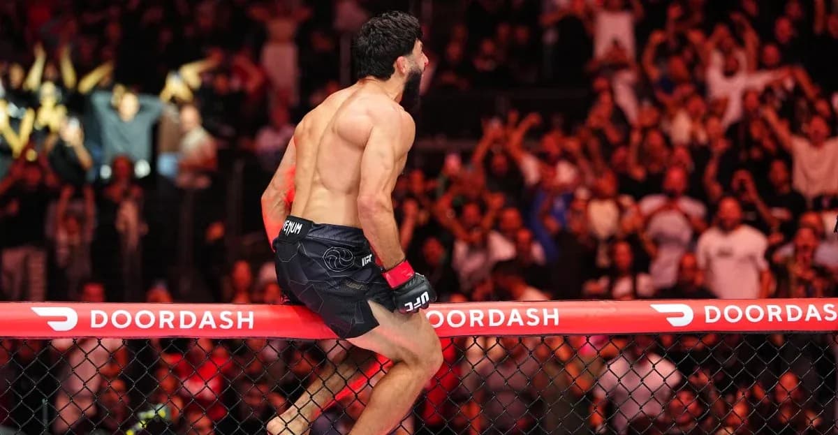 Fighter celebrating on cage after victory in match