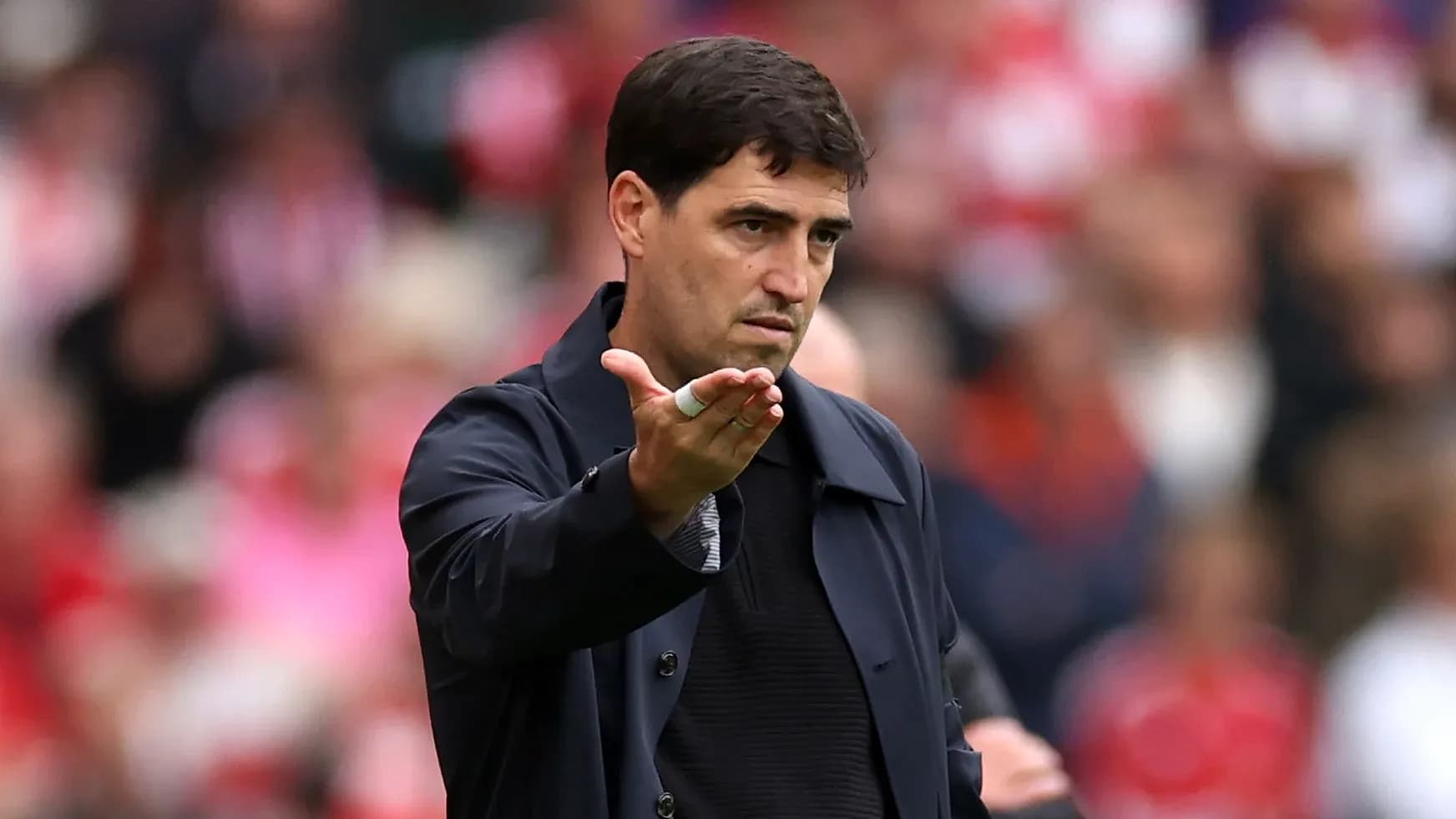 Manager gesturing during a football match on the sideline