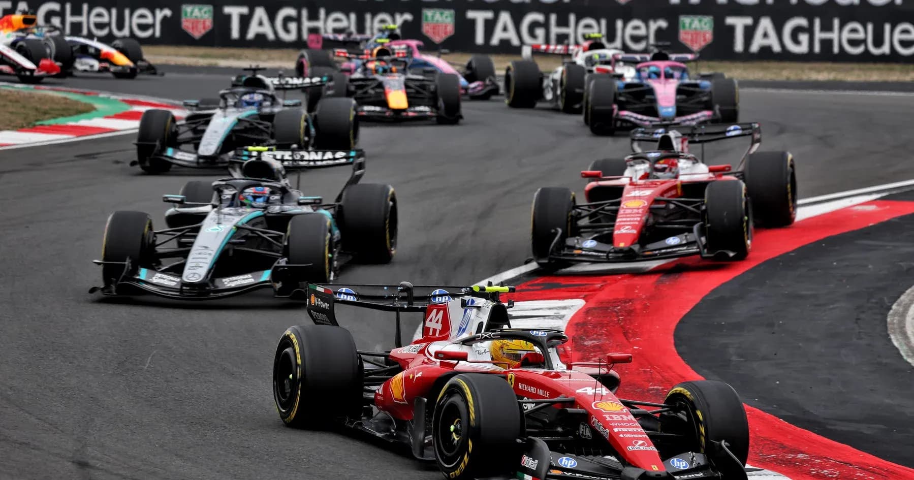 Multiple Formula 1 cars racing on track