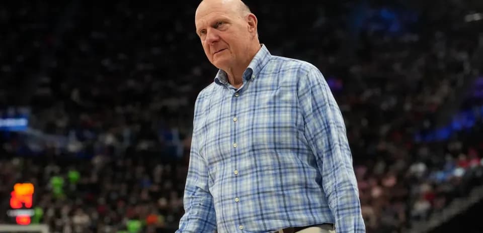 Man in plaid shirt walking on basketball court