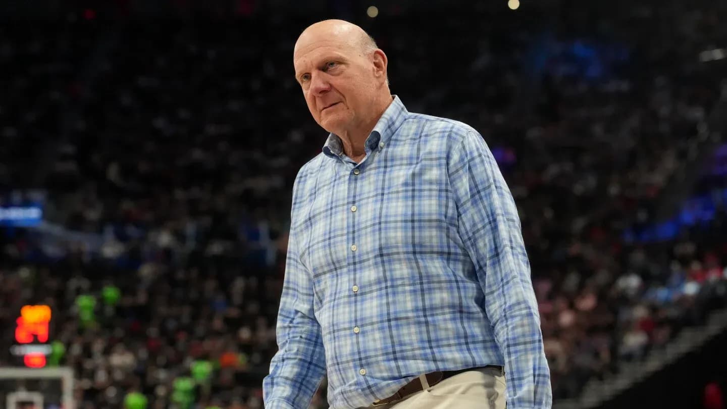 Man in plaid shirt walking on basketball court
