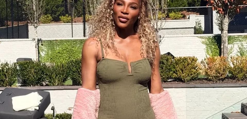 Person posing outdoors in swimsuit and jacket