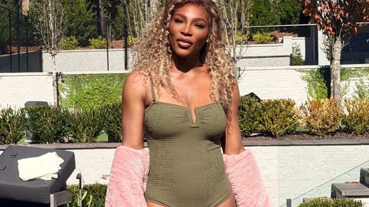 Person posing outdoors in swimsuit and jacket