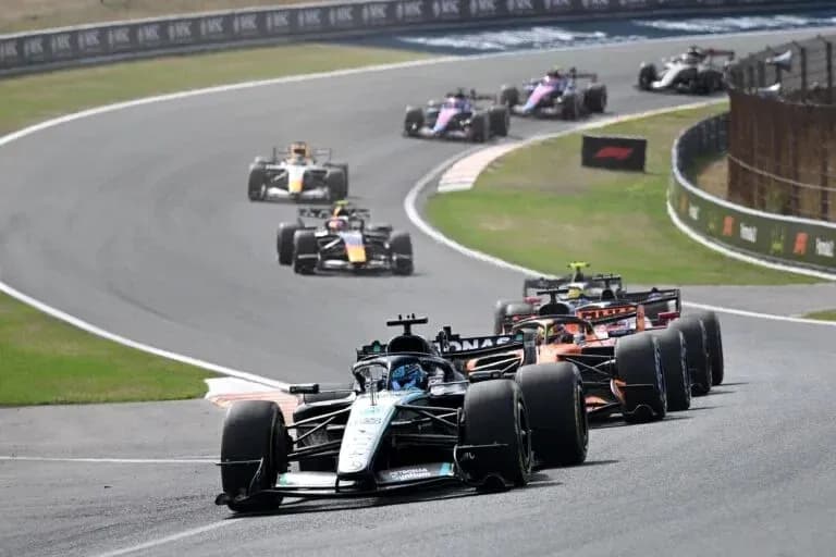 Formula 1 cars racing on a winding track