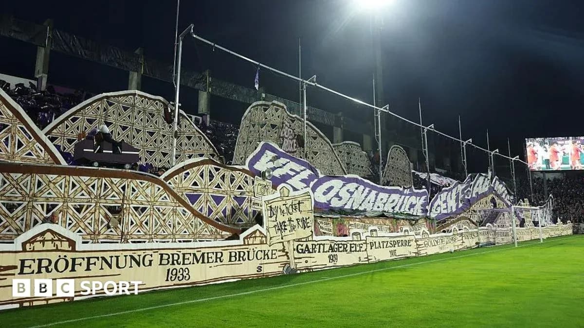 Fans displaying a large banner at the stadium