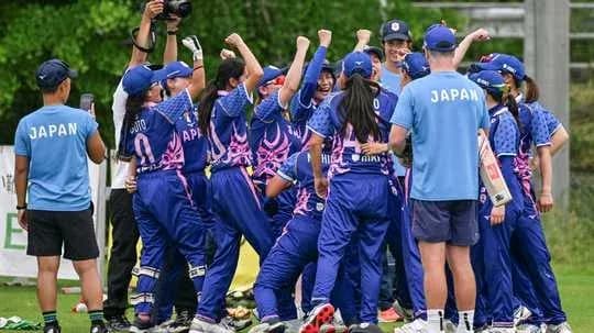 Japanese women's cricket team celebrating victory on field