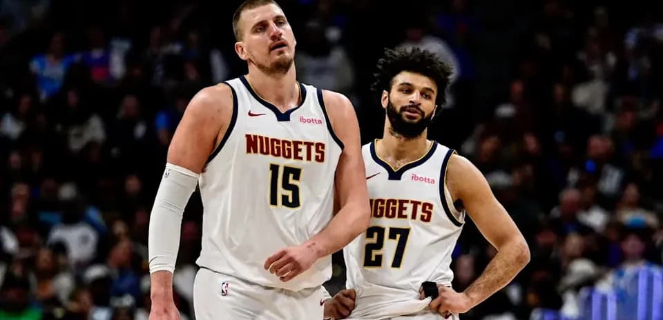 Two Denver Nuggets players walking off the court