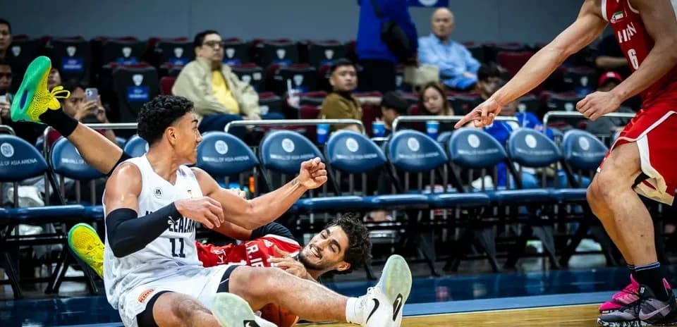 Players on the floor during intense basketball play